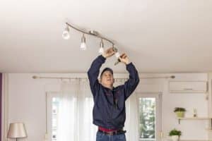 man changing energy saving light